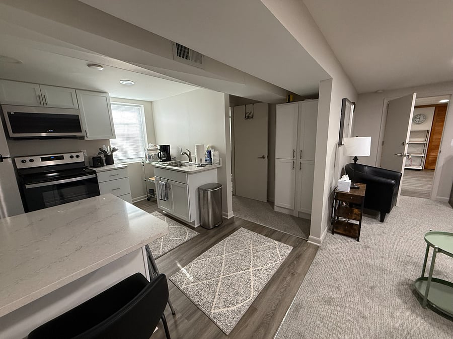 Overview of kitchen with SS appliances and quartz countertops