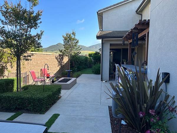 Outdoor living area with built-in BBQ and seating.