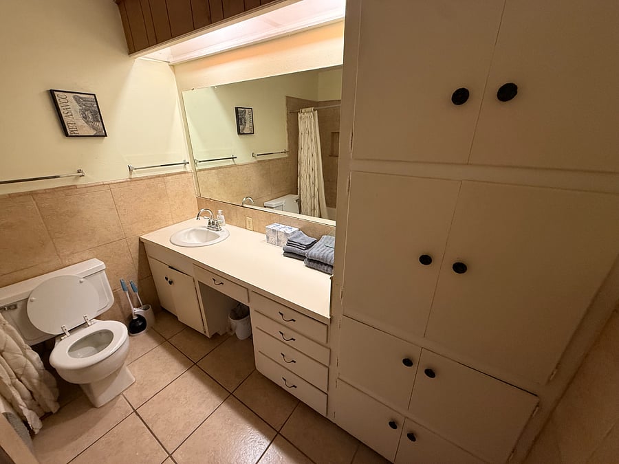 Bathroom next to kitchen with tub/shower