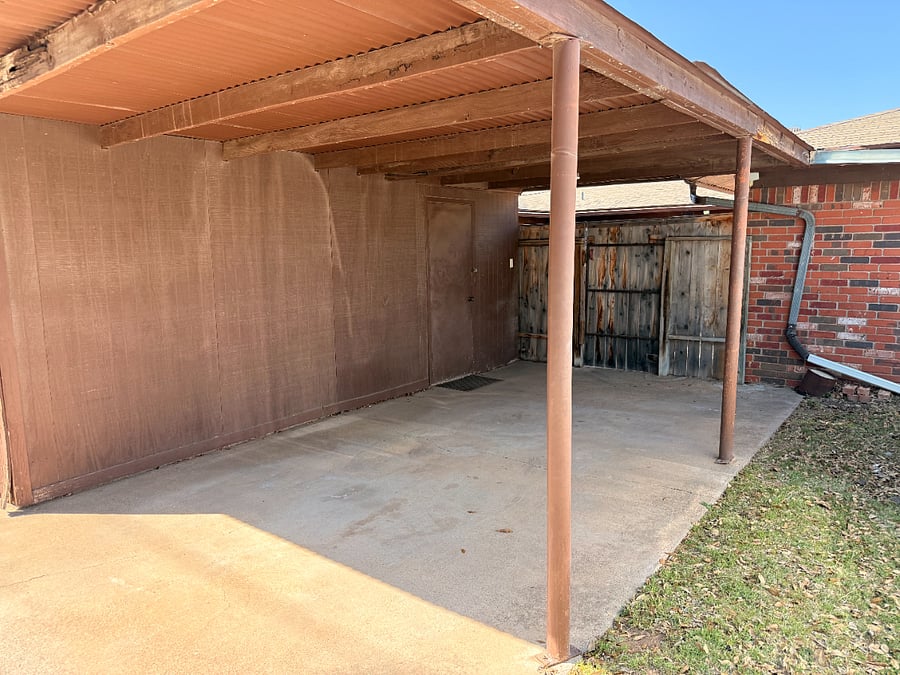 Carport for one vehicle in rear of property.  Small patio that leads to back door by the kitchen.