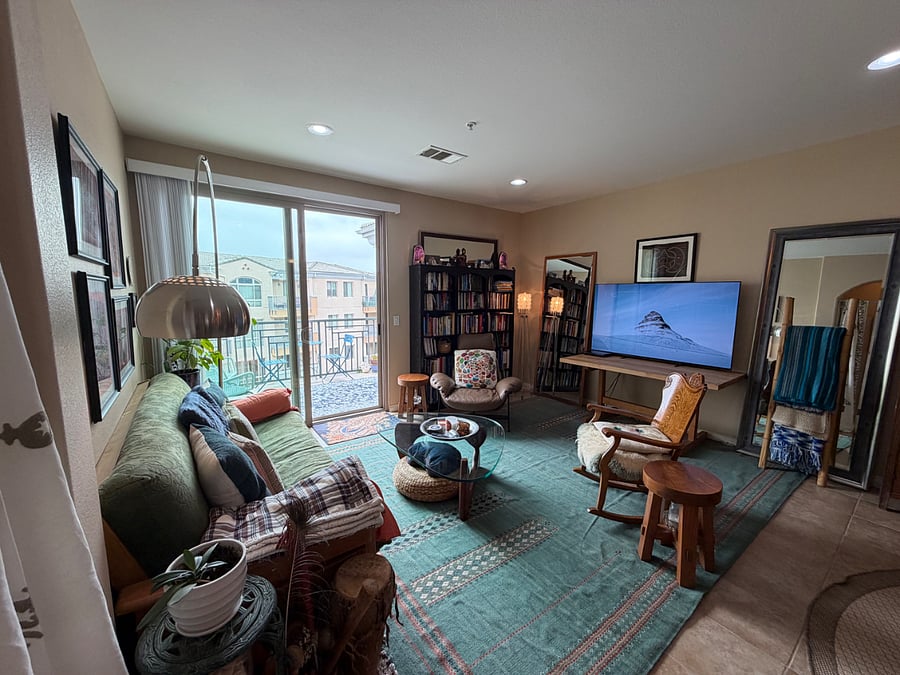 another view of living room and balcony which faces west.