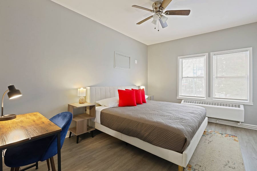 Bedroom 1. Includes:
King bed, air conditioning, bed linens, black out curtains (not shown), heating, dedicated work space with table, chair and lamp.