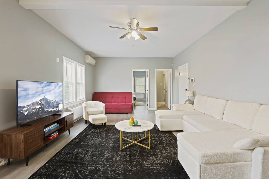 Living room. Includes: Couch, air conditioning, heating, TV, dedicated work table lamp, table and chair.