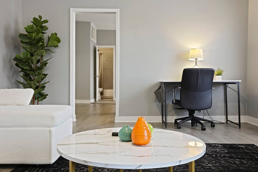 Living room. Includes: Couch, air conditioning, heating, TV, dedicated work table lamp, table and chair.