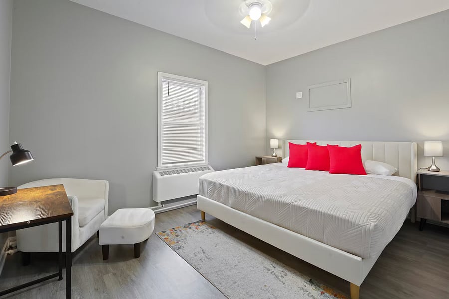 Bedroom 2. Includes:
King bed, air conditioning, bed linens, heating, black out curtains (not shown), dedicated work space with chair (not shown), table and table lamp.