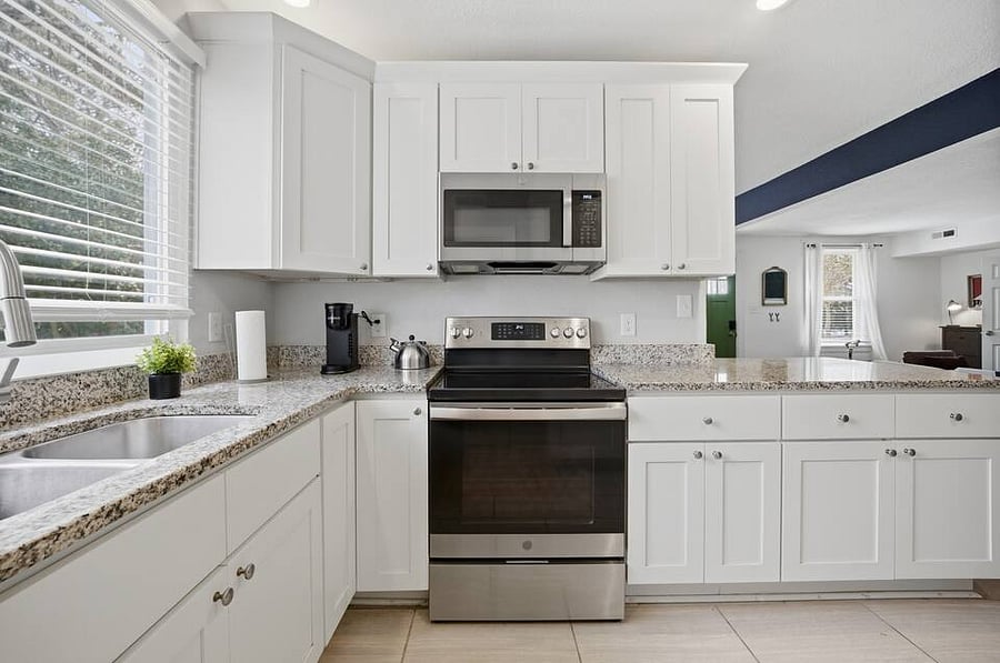 Full kitchen setup with updated appliances.