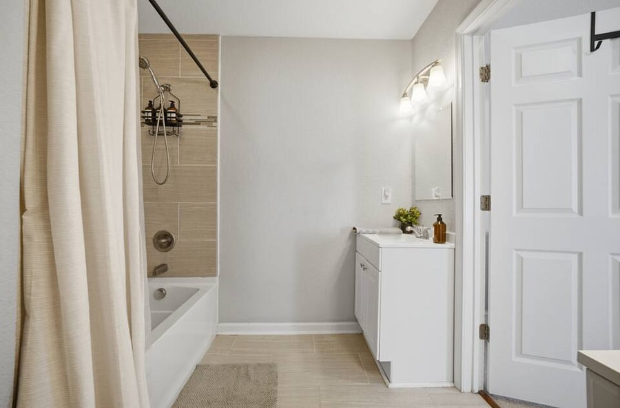 Primary en-suite bathroom with 2 vanity sinks.