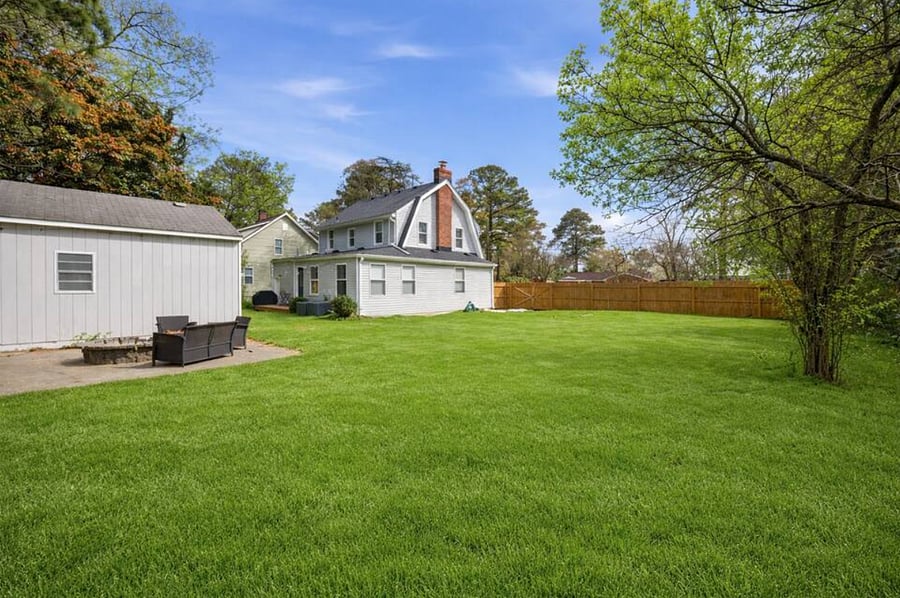 The huge backyard includes a deck and grill. Perfect for kids or pets that want to run around. 