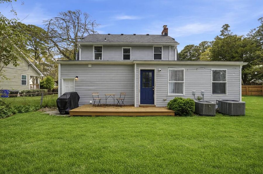 The huge backyard includes a deck and grill. Perfect for kids or pets that want to run around. 