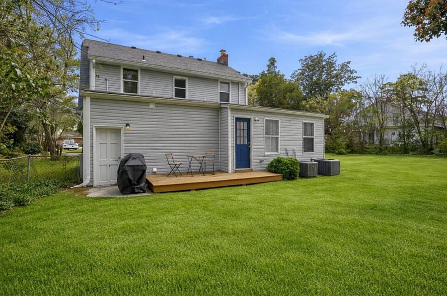 The huge backyard includes a deck and grill. Perfect for kids or pets that want to run around. 