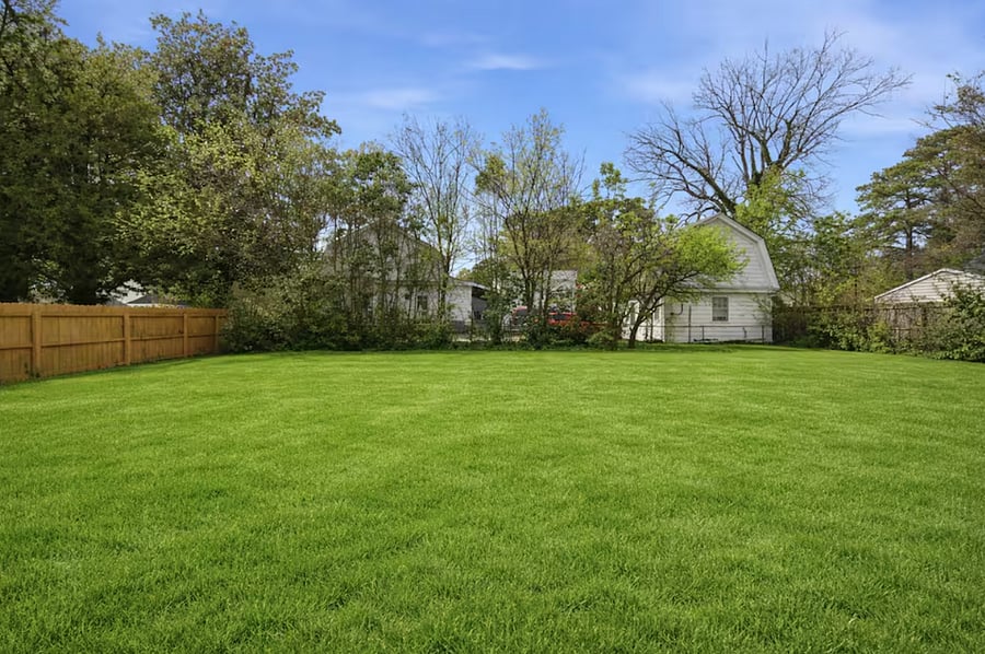 The huge backyard includes a deck and grill. Perfect for kids or pets that want to run around. 