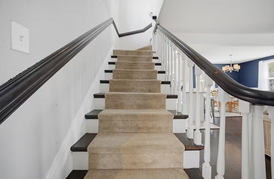 Large, beautiful stairwell leading up to the second floor.