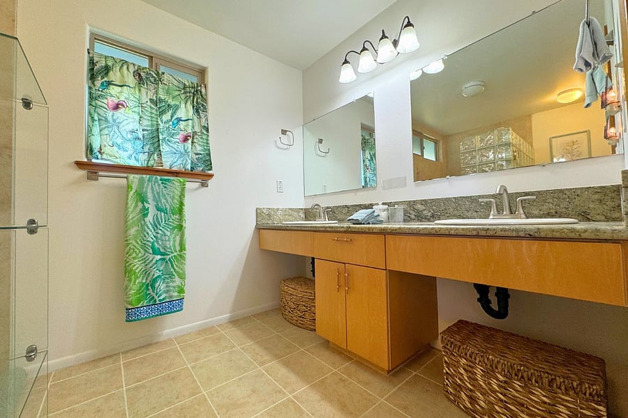 Main bedroom attached bath with walk-in shower and double vanity.