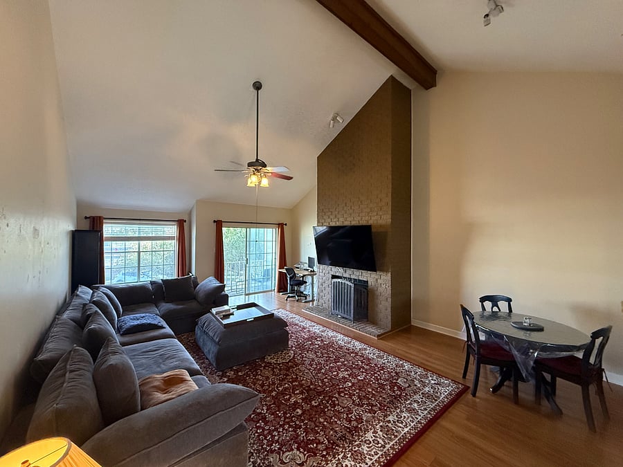Upstairs living room with high ceilings, smart TV, and huge comfy couch