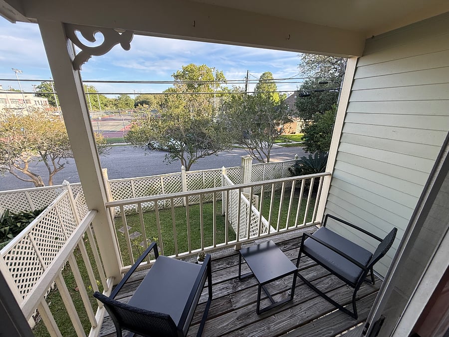 Upstairs balcony overlooking publicly accessible tennis courts
