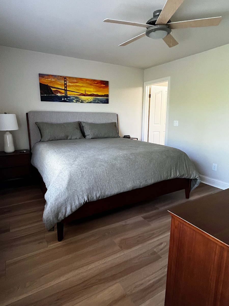 Primary Bedroom with King bed. Room has ceiling fan.