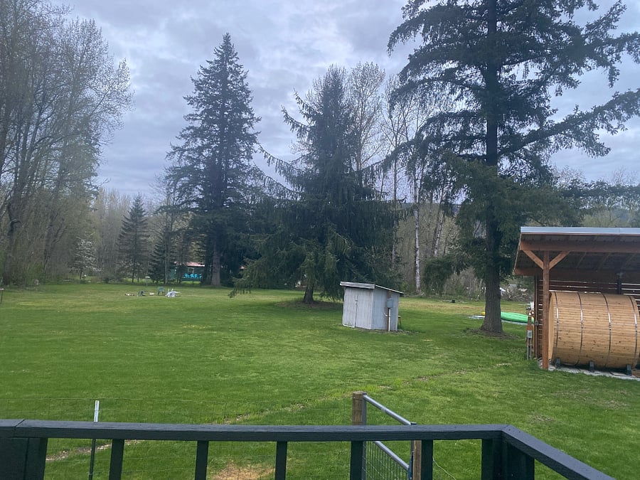 View of the expansive property from your private back deck. Price and peaceful and just steps to the Sauna