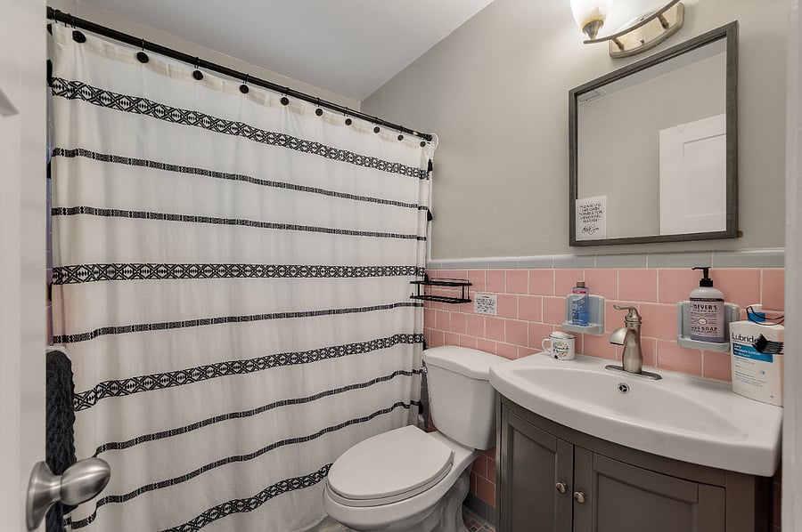 A pink bathroom! This bathroom has a great shower and plenty of amenities. We supply hand soaps, lotion, shampoo, conditioner, body wash, blow-dryer, makeup remover, extra toilet paper, white towels, black towels for makeup removal and much more!