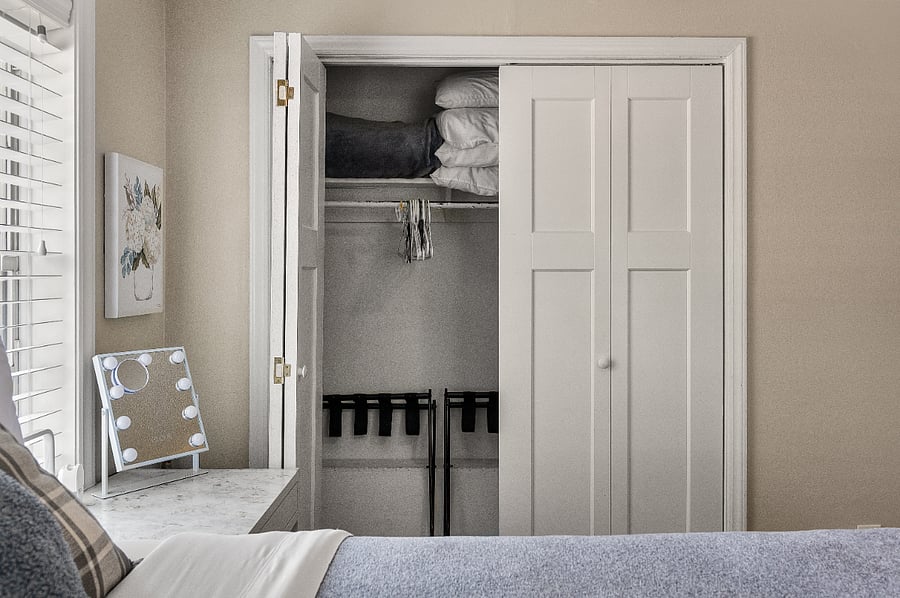 Extra pillows, extra blanket, luggage racks, nightstand, light-up portable mirror, bedside phone charger/tap light and lots of closet space! The secondary bedroom has the same closet items except the blanket in that bedroom is light blue.