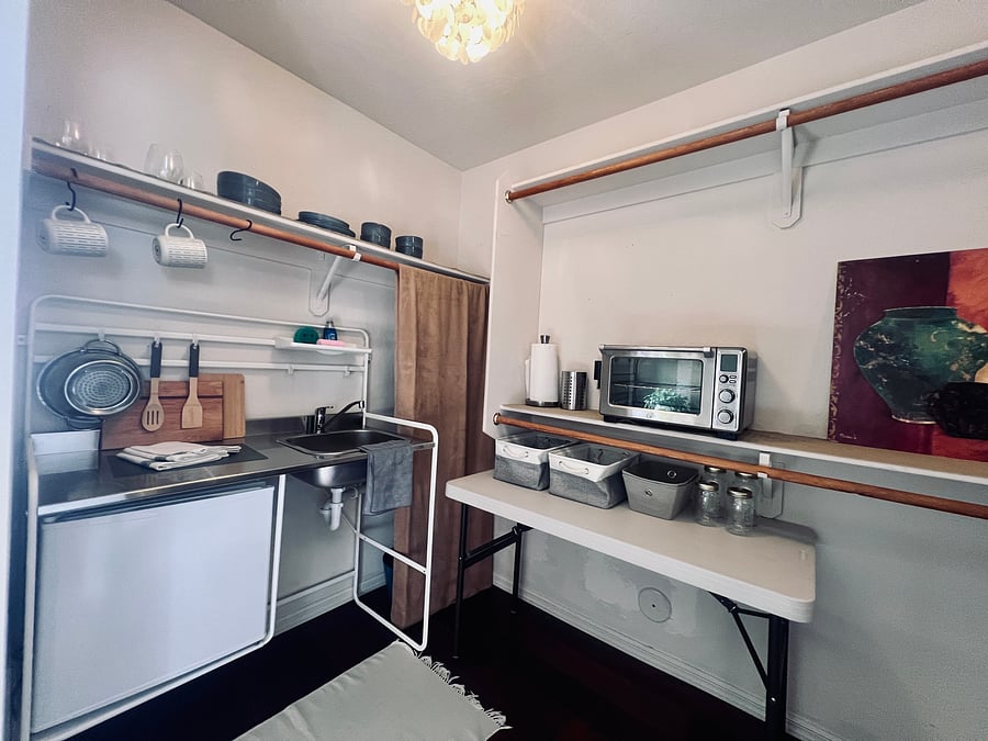 Kitchenette and moveable workspace table.