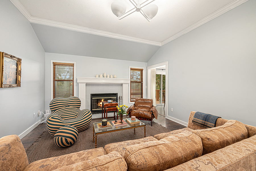 An inviting living space centered around a fireplace, with comfortable seating and natural light creating a calm, welcoming atmosphere.