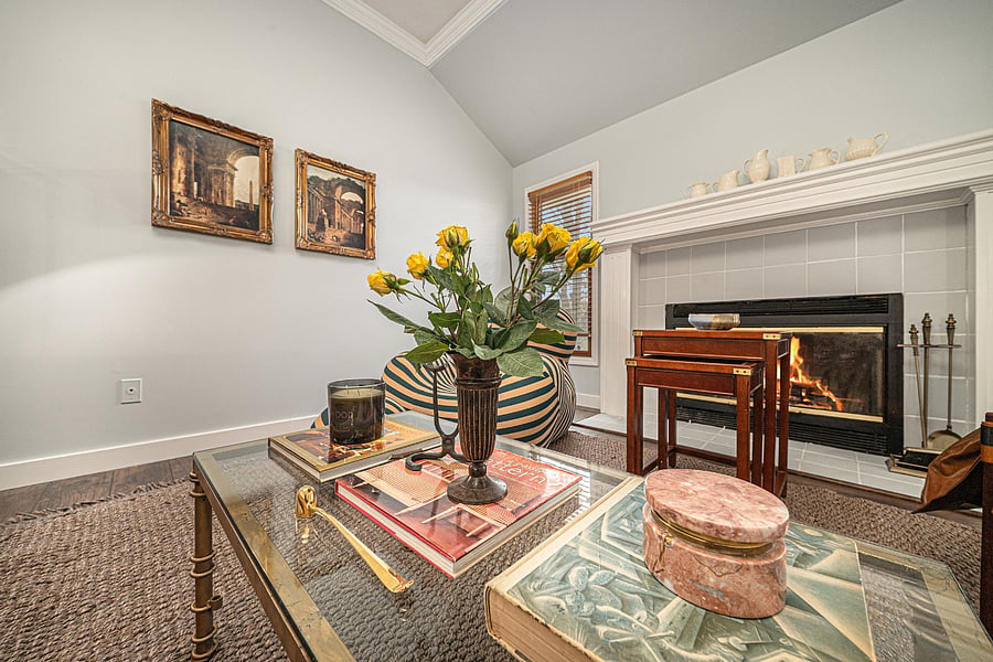 A warm fireside nook with elegant dcor and soft textures, perfect for quiet moments, reading, or relaxing by the glow of the fireplace.