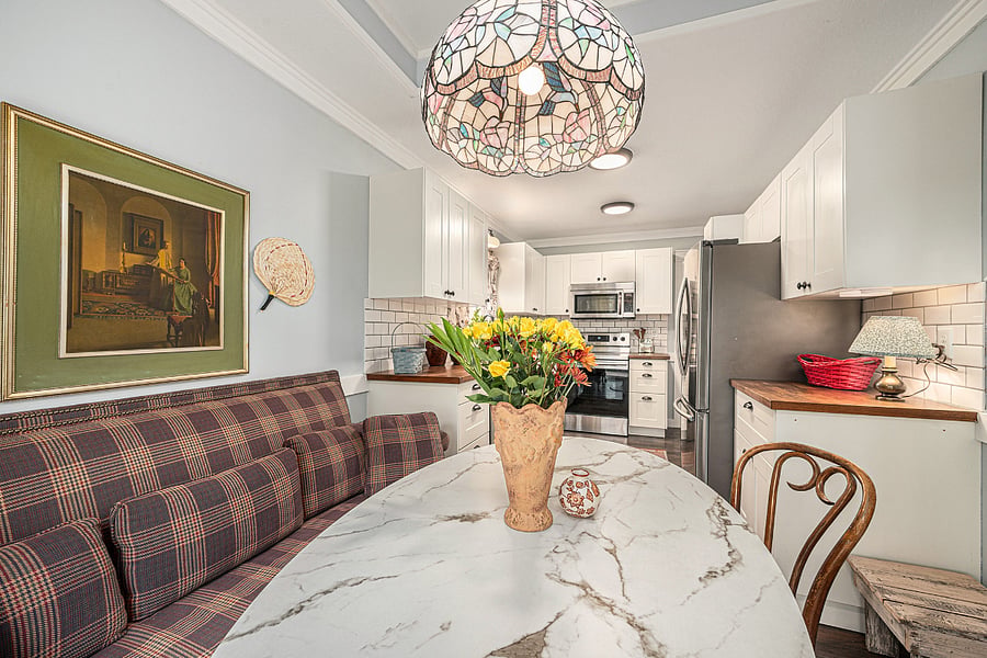 A bright dining area with a marble table and cozy bench seating, ideal for shared meals, morning coffee, and easy conversation.