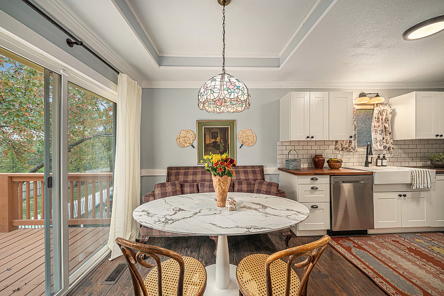 A charming dining space bathed in natural light, with views outside and a welcoming table that invites guests to linger.