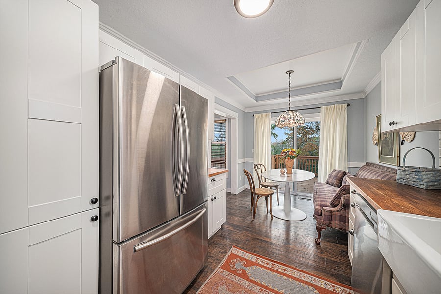 Clean and modern kitchen with complete appliances, ample storage, and a spacious 2-door fridge, fully equipped for effortless cooking and daily living.