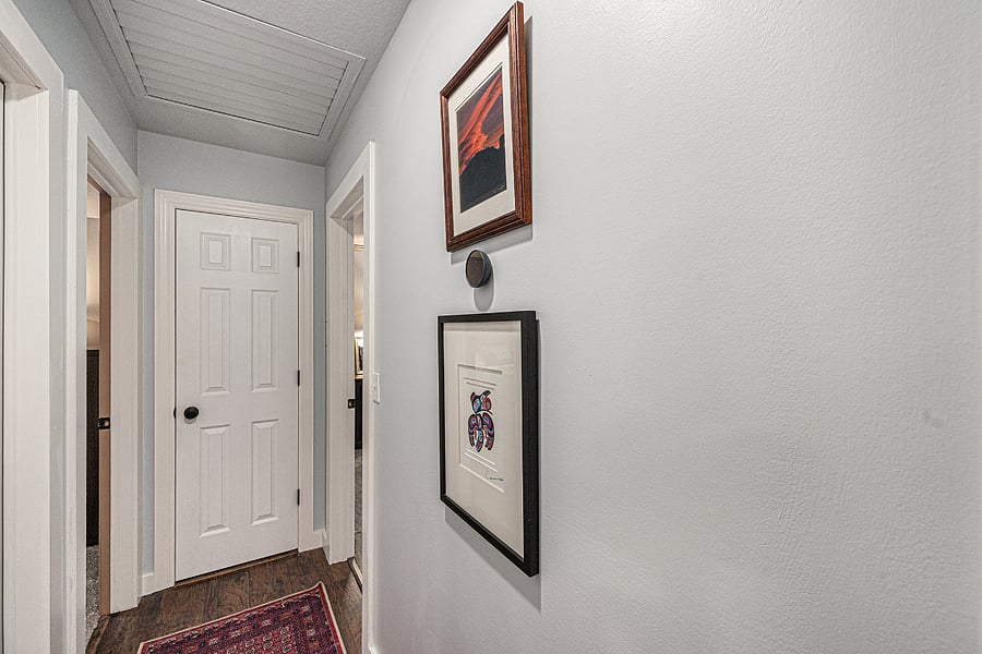 The hallway connecting the bedrooms features tasteful, understated dcor, creating a serene and refined passage through the home.