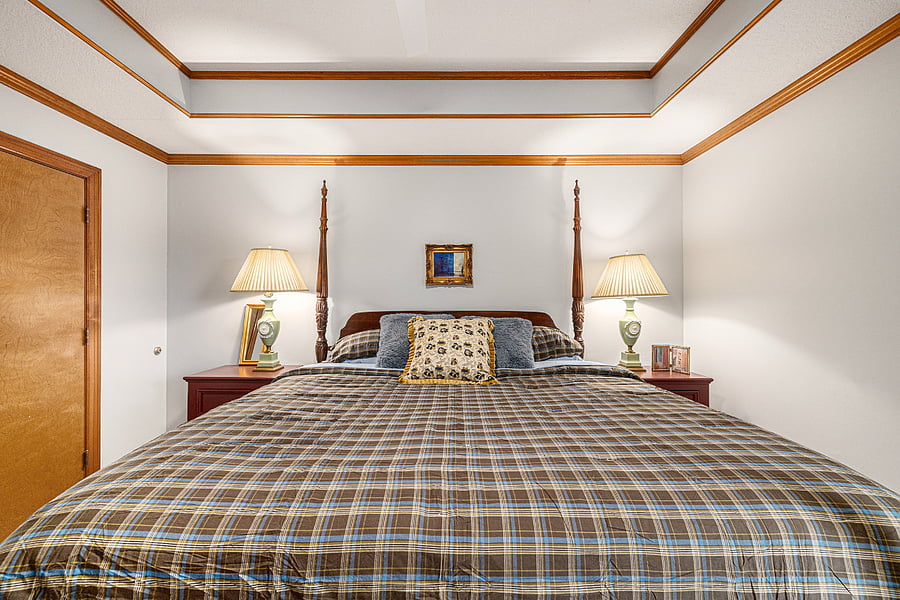 Relax in a well-appointed bedroom where bedside tables and lamps add warmth, comfort, and convenience to the sleeping area.