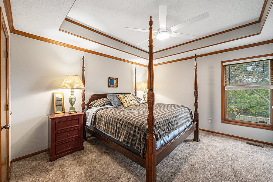Spacious bedroom with a floor-covering rug, creating a warm and inviting retreat filled with natural light.