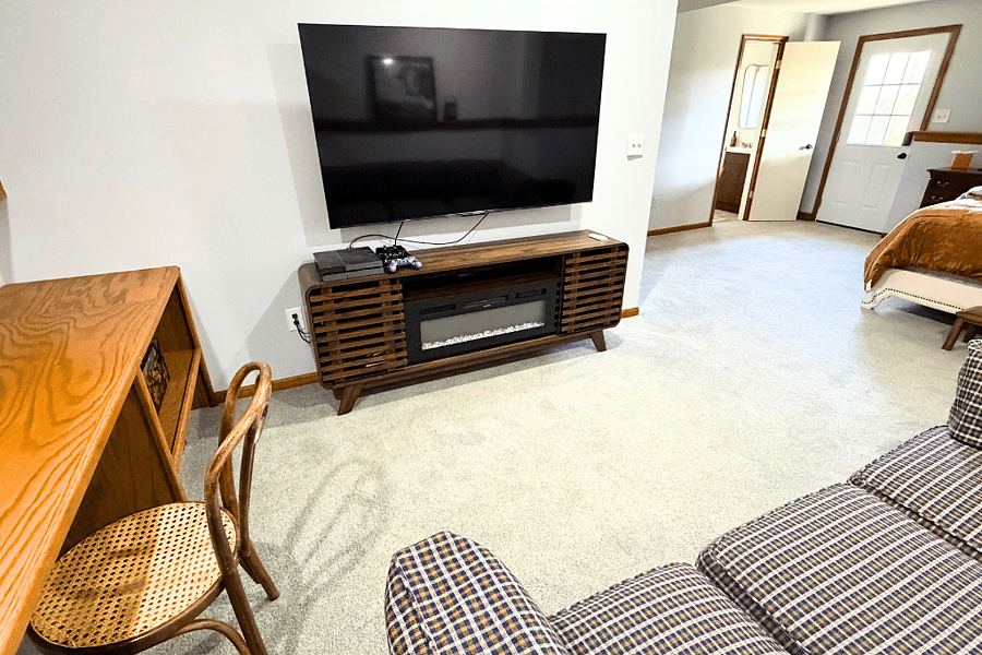 The ultimate hangout spot: a long cozy couch, side tables, TV, and PS4 make this family room ideal for games, movies, and quality time with loved ones.