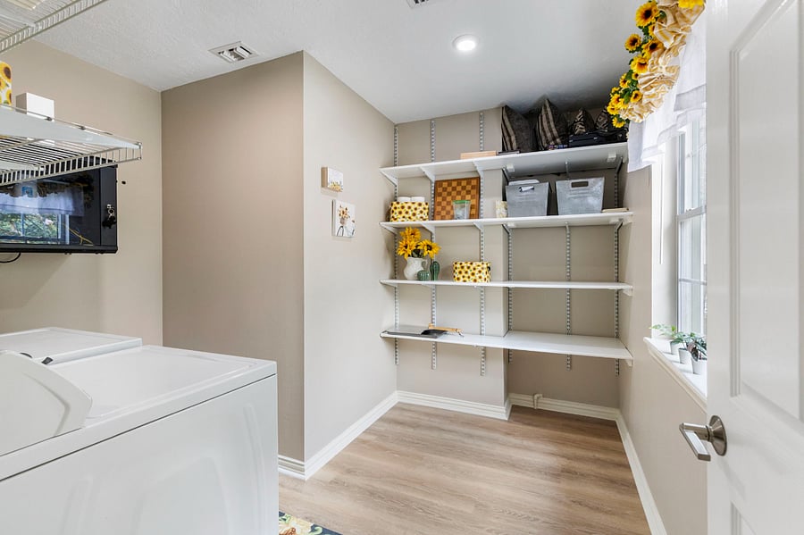 Laundry room and pantry has plenty of storage.