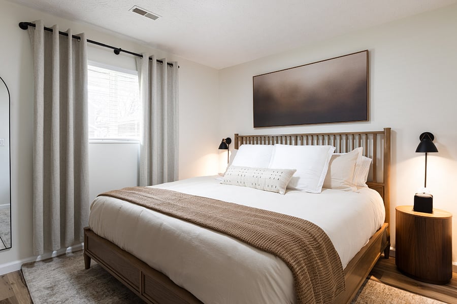 Second bedroom with king mattress, blackout curtains and cozy bedding