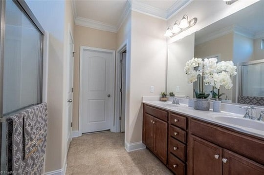 Master en-suite bathroom w/ double vanity, linen closet, toilet room & master's walk-in closet.