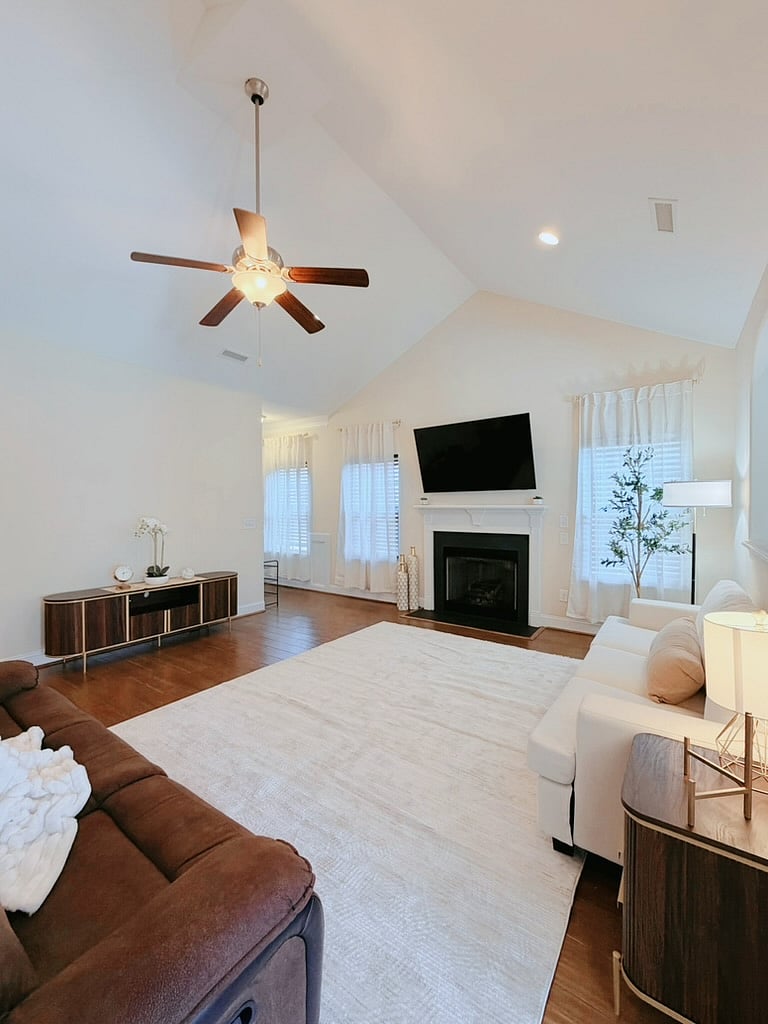 Spacious living room w/ 65 inch smart tv, sofa and reclining sofa w/ throw blanket. 
Side table has convenient outlet and USB ports.