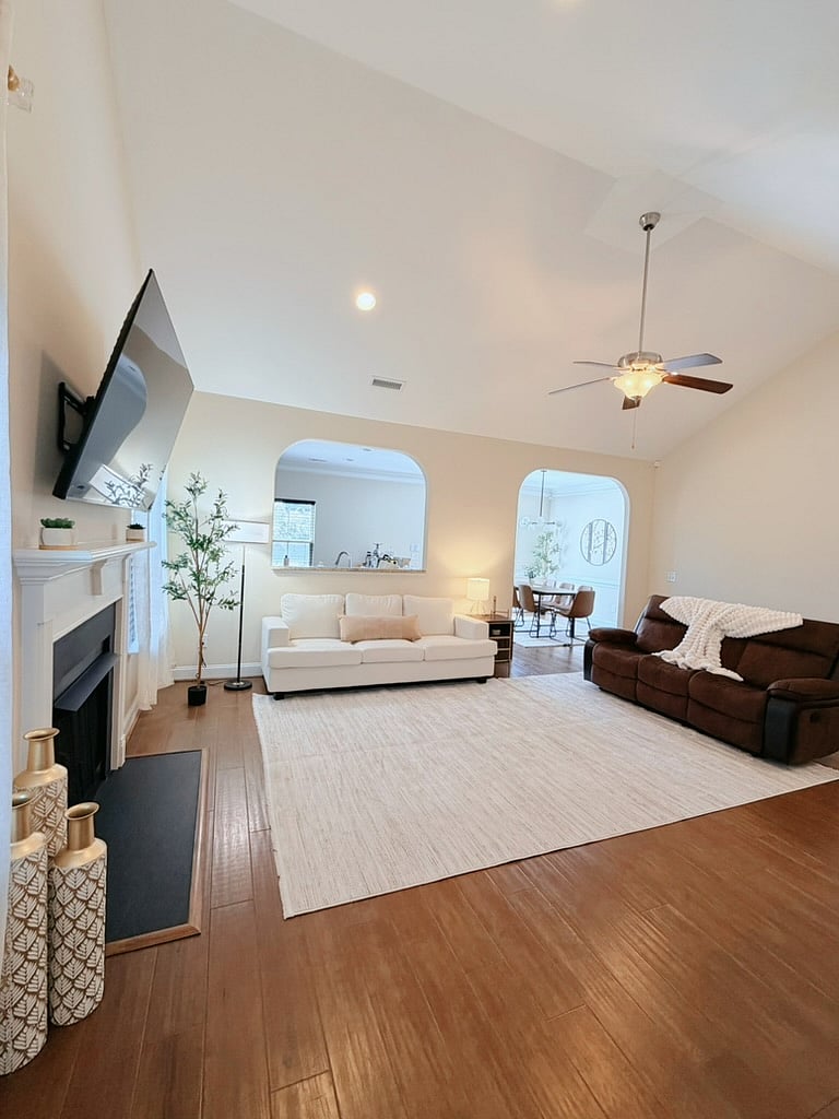 Spacious living room w/ 65 inch smart tv, sofa and reclining sofa w/ throw blanket. 
Side table has convenient outlet and USB ports.