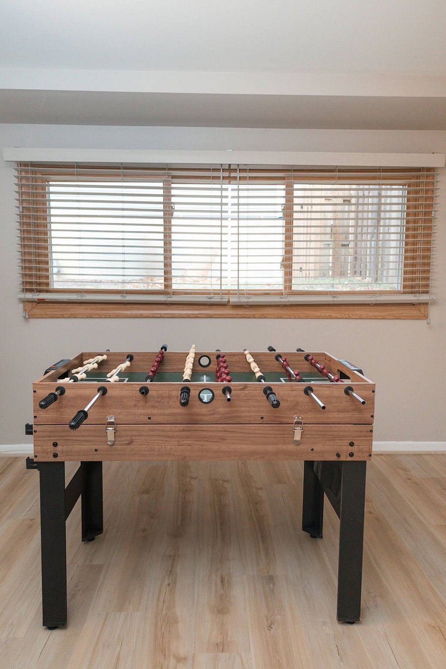 Furnished basement with Smart TV, sleeper couch and game area.