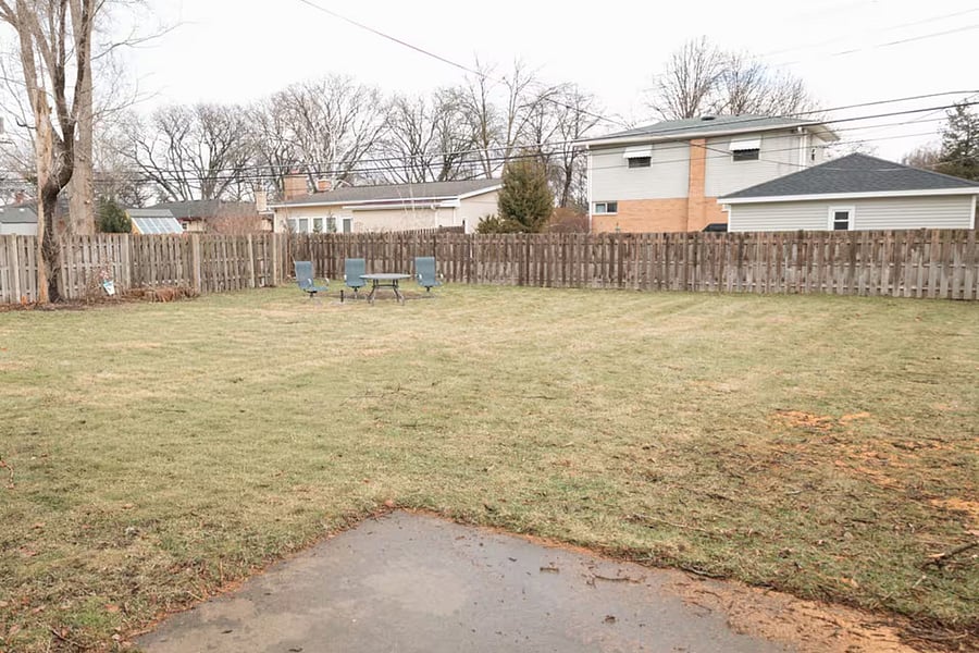 Fenced backyard with patio set