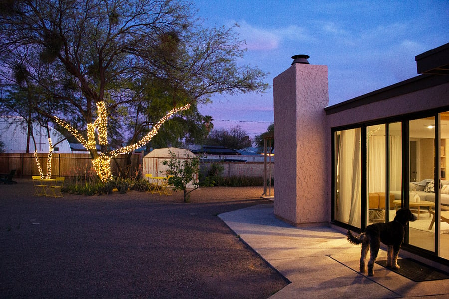 A calm desert evening. Warm interiors, soft light, and space to gather.