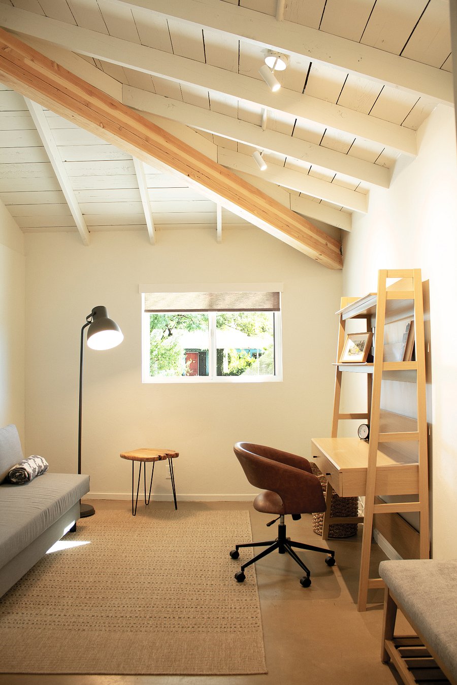 Quiet bedroom with vaulted ceiling and dedicated workspace. Ideal for remote work or extended stays.