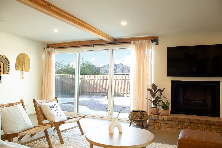 Light-filled living room with fireplace and seamless indoor-outdoor access.