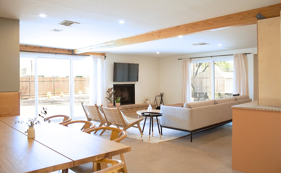 Spacious living room with fireplace and direct access to backyard.