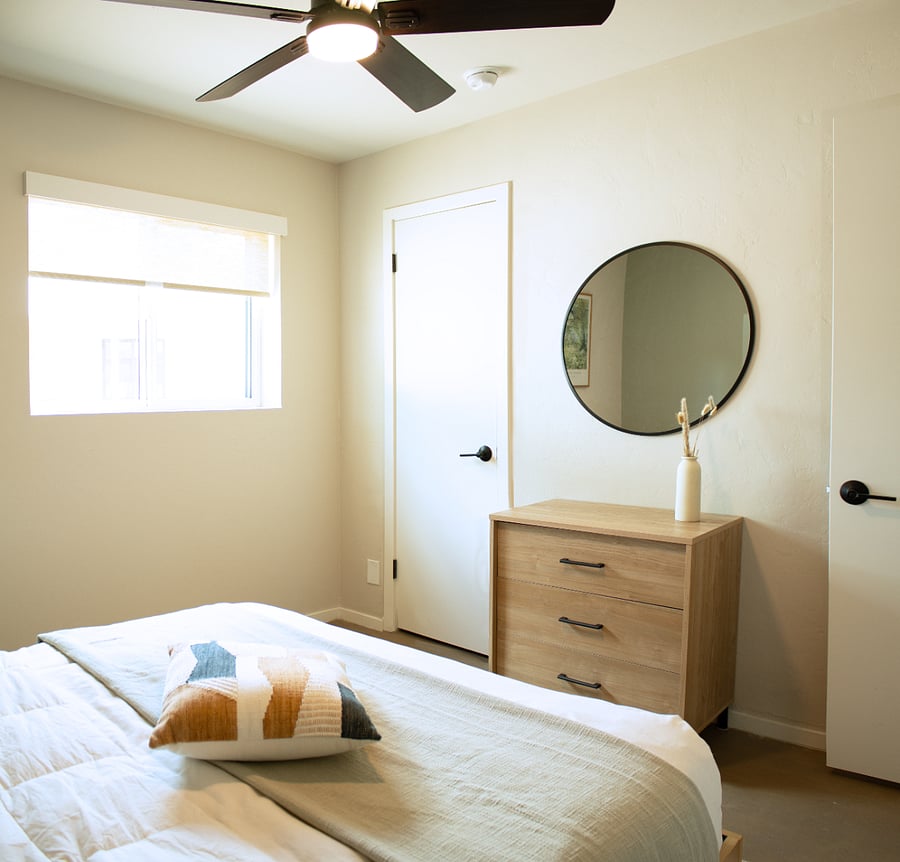 Bright bedroom designed for rest and comfort with clean, modern furnishings.