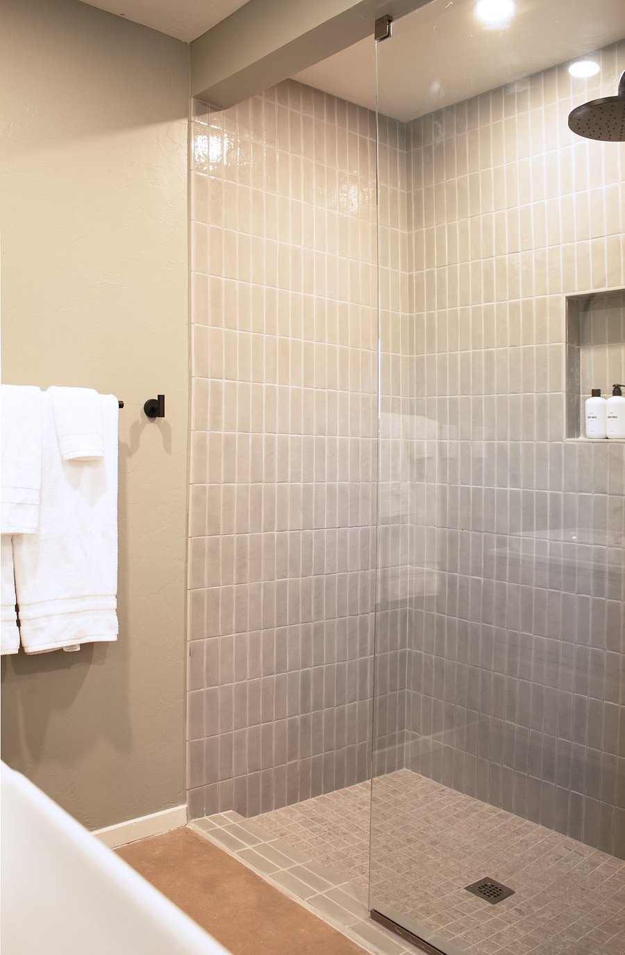 Spacious walk-in shower with contemporary tile and fixtures.