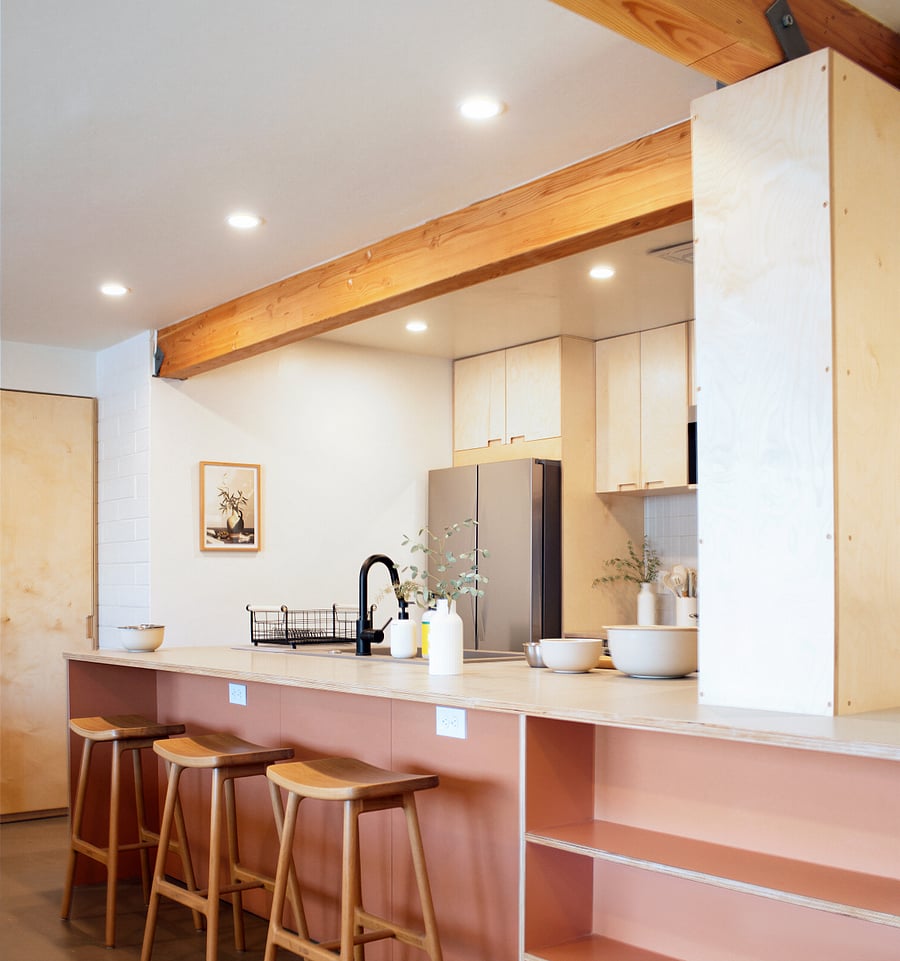 Modern kitchen with breakfast bar seating and open layout.