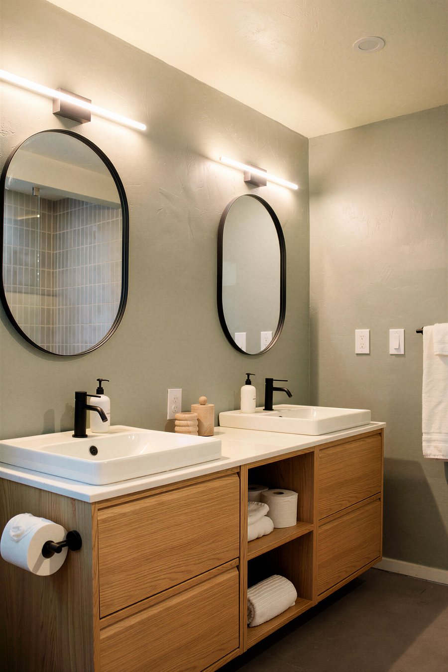 Spacious dual vanity featuring warm wood tones, sleek vessel-style sinks, and clean minimalist lightingperfect for seamless morning routines.