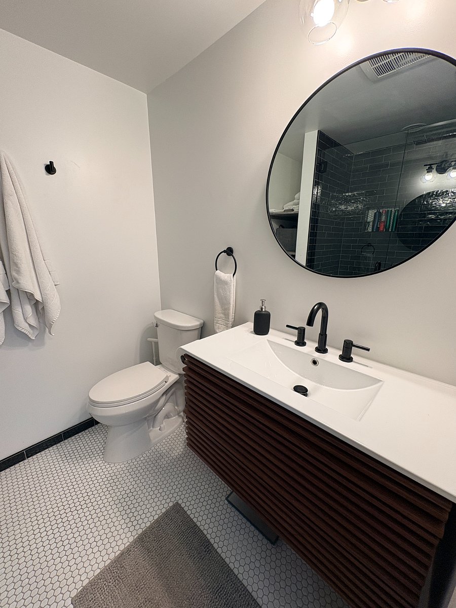 Bathroom featuring fully-tiled shower, Euro-glass doors