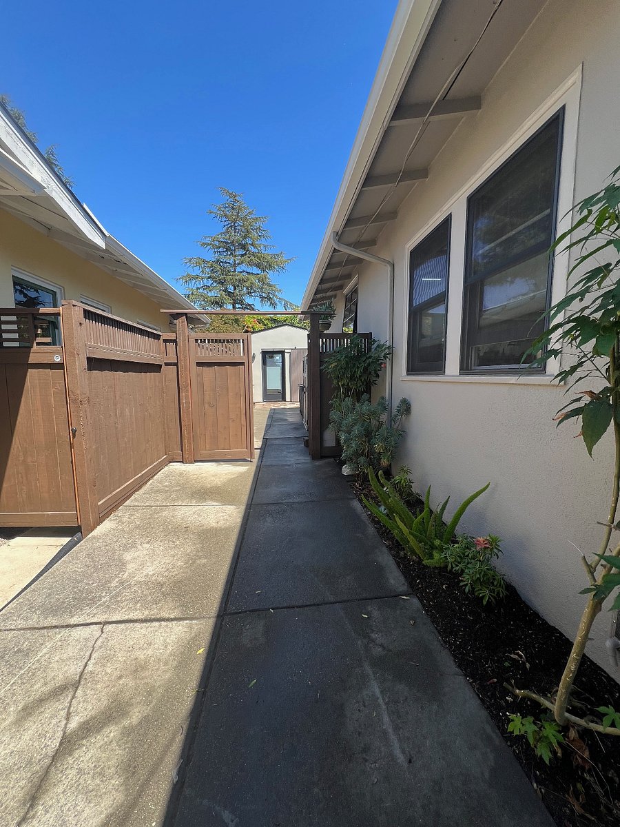 Full / single car driveway to left of house.
Leads to privacy gate w/secure code.
Locked gate and fence on the other / East side of the house as well.